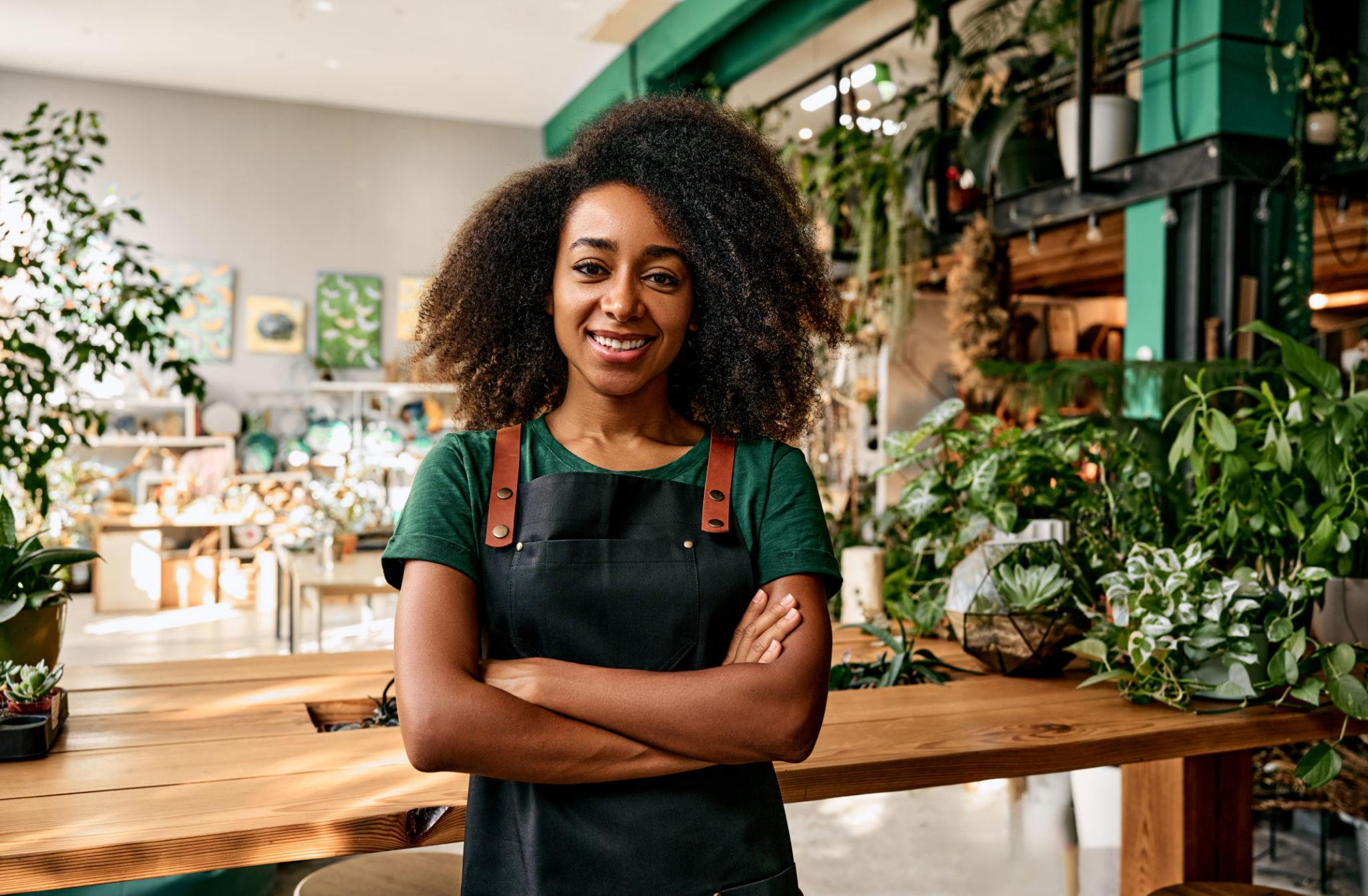 Business owner standing inside her plant shop